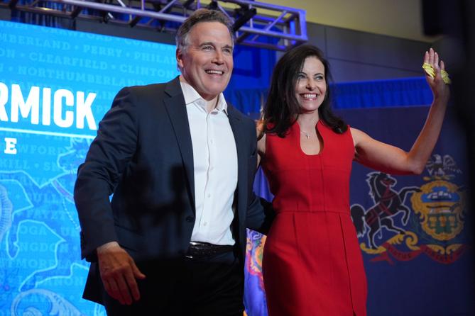 Dave McCormick, left, arrives to speak with his wife, Dina Powell, during an election night watch party, Wednesday, Nov. 6, 2024, in Pittsburgh.