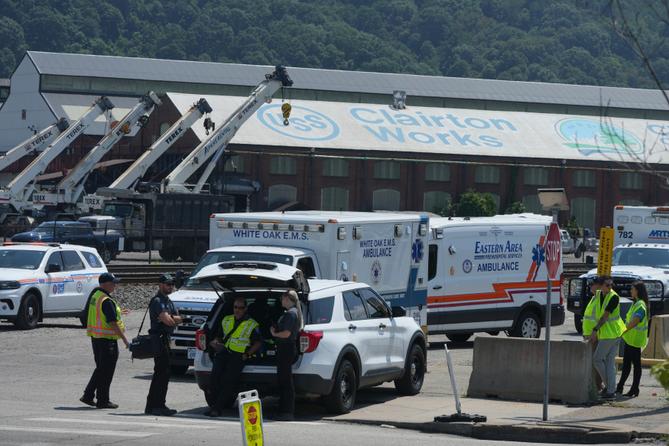 Emergency crew gather after an explosion at the Clairton Coke Works, a U.S. Steel coking plant, Monday, Aug 11, 2025, in Clairton.