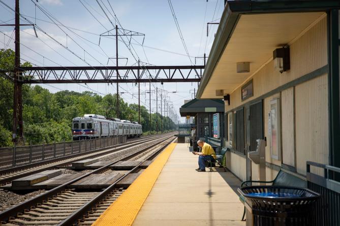 A man sits on a SEPTA platform.