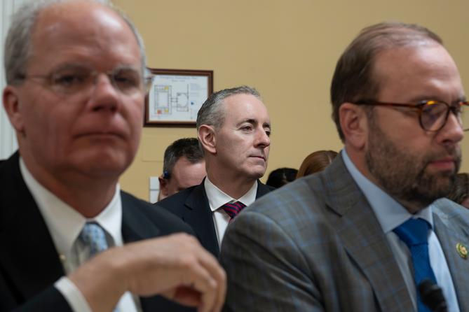 PA Republican Rep. Brian Fitzpatrick (center, rear) is framed by Rep. Brett Guthrie (left) and Rep. Jason Smith (right) at the Capitol in Washington, Tuesday, Dec. 16, 2025.