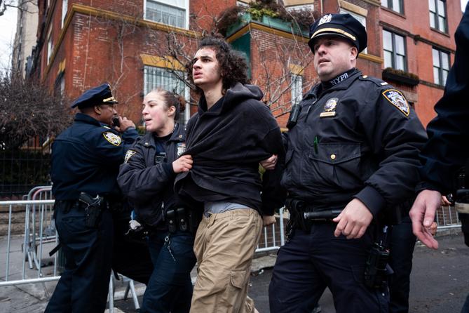 Police detain Emir Balat after he attempted to detonate an improvised explosive device during a counterprotest against far right influencer Jake Lang staging an anti-Islam protest outside Gracie Mansion, Saturday, March 7, 2026, in New York