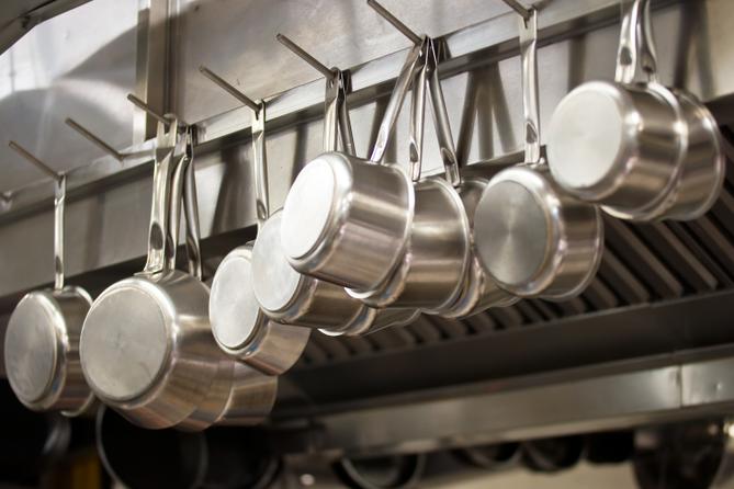 A stock image of pans hanging in a restaurant.