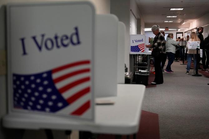 People fill out mail ballots for the 2024 election in West Chester, Pa.