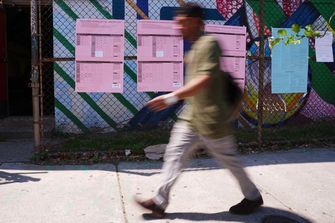 A person walks past sample ballots outside a polling place in Philadelphia, Tuesday, May 19, 2026.