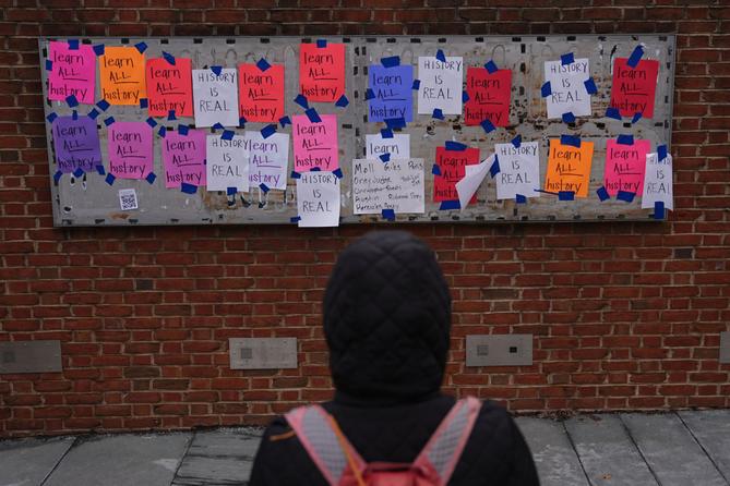 A person views posted signs on the locations of the now removed explanatory panels that were part of an exhibit on slavery at President's House Site in Philadelphia, Jan. 23, 2026. A person views posted signs on the locations of the now removed explanatory panels that were part of an exhibit on slavery at President's House Site in Philadelphia, Jan. 23, 2026.