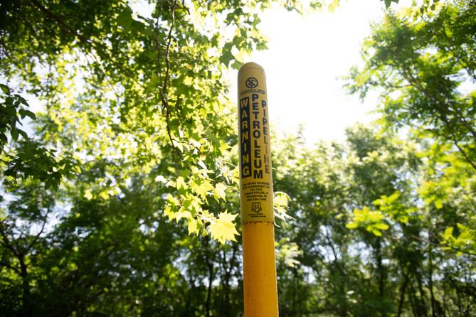 A marker for an Energy Transfer petroleum pipeline stands near the Delaware River in Upper Makefield Township, Pa.