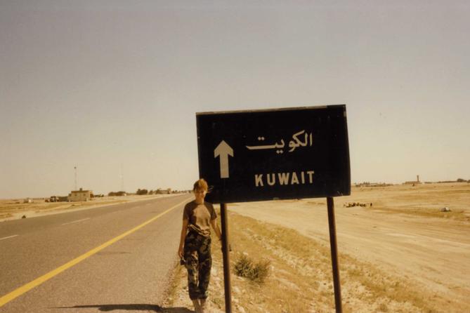 Pennsylvania Treasurer Stacy Garrity, now a candidate for governor, poses near a sign during her military service.