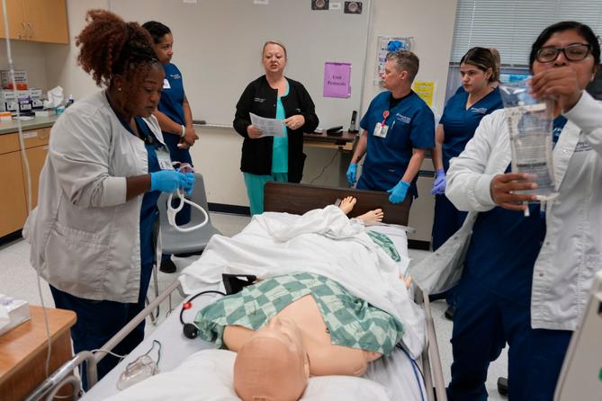 Instructor Renee McFatridge, center back, directs nursing students in the simulation lab at Forsyth Technical Community College in Winston-Salem, N.C., Thursday, Aug. 20, 2026