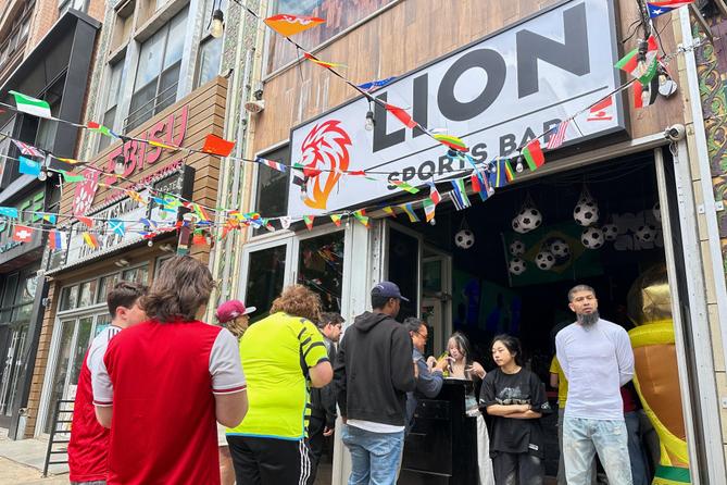 Fans arrive to watch a Champion league soccer match between Arsenal and Paris Saint-Germain at the Lion Sports Bar, in Philadelphia.