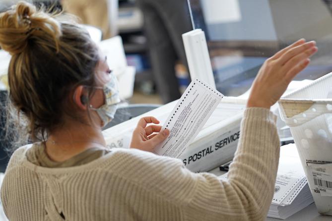 Mail-in ballots are sorted and counted by workers on Election Day 2020 at Northampton County Courthouse.