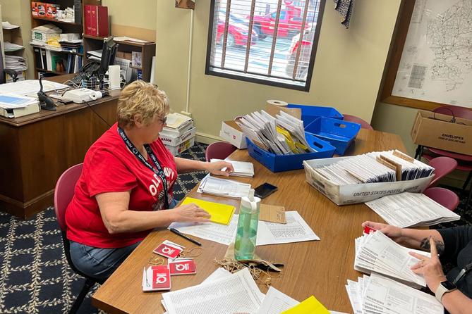 Marcie Strachko, Columbia County’s human resources director, processes mail ballots during the 2023 municipal primary.