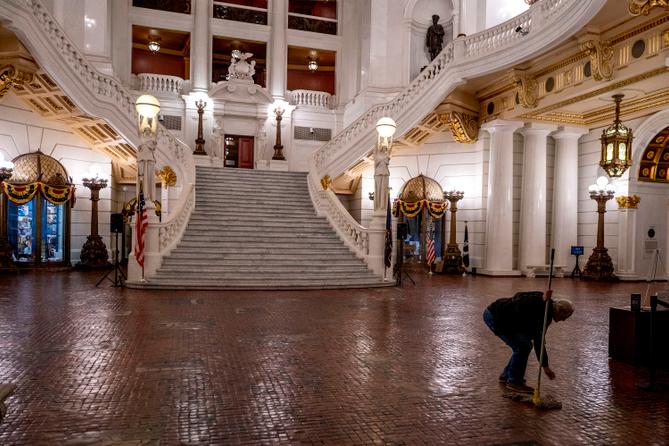 Robert Turner cleans the Moravian tiled floor after hours in the rotunda of the Pennsylvania Capitol in Harrisburg.
