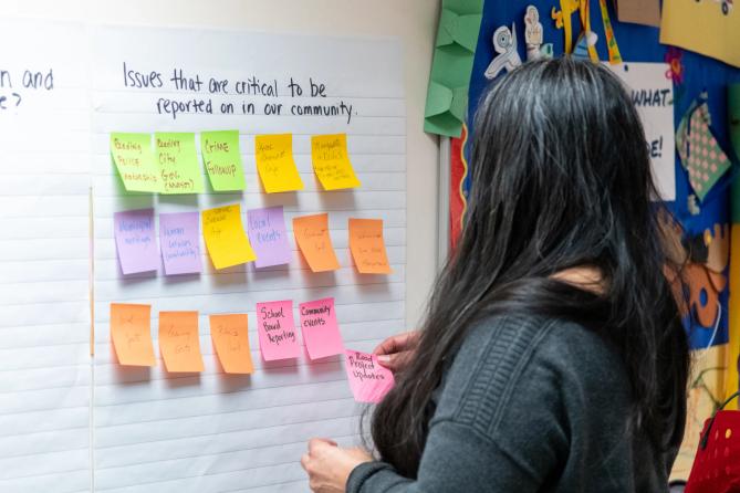 A woman in Berks county puts up a Post It note listing issues critical to her community